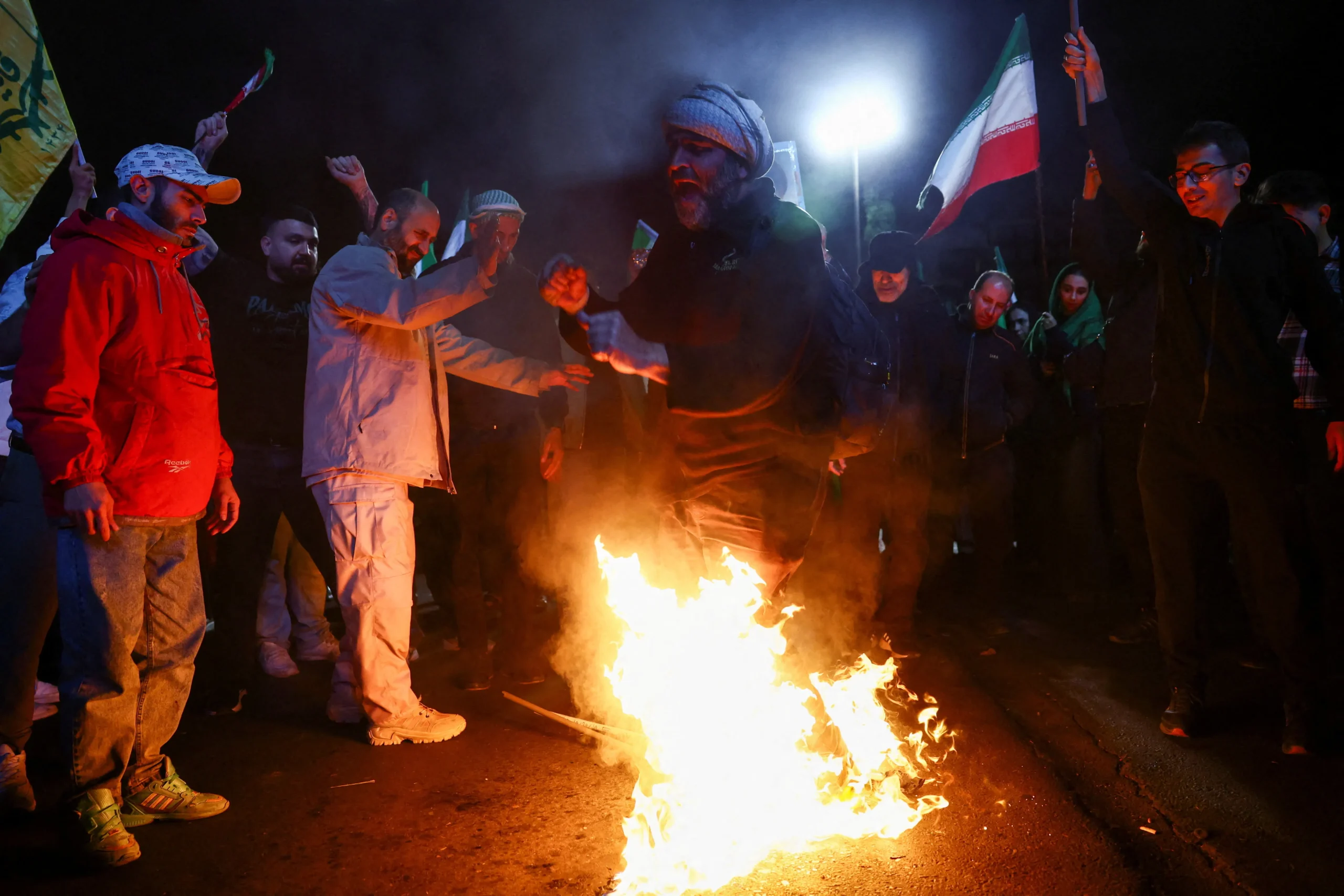 man-stomps-burning-flags-u-1072040134
